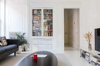 A Pair of Designers Renovate Their Brooklyn Brownstone With a Bright Monochromatic Palette - Photo 8 of 12 - The TV room features a USM credenza for the television; the couple’s Petrie sofa is from Crate and Barrel. The coffee table is custom.
