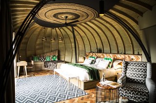 Take an Eco-Escape to a Spherical Forest Villa in an Eroded Volcanic Cone in Rwanda - Photo 2 of 10 - Each spacious 980-square-foot forest villa is made up of a bedroom, reception space, and bathroom. It's warmed by a central fireplace and features breathtaking views from the private deck looking toward Mount Bisoke.