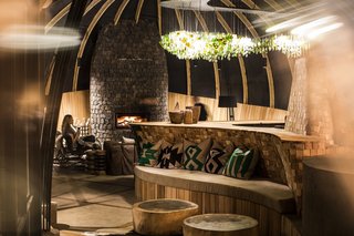 Take an Eco-Escape to a Spherical Forest Villa in an Eroded Volcanic Cone in Rwanda - Photo 5 of 10 - "The emerald green color in the textiles and chandeliers is reminiscent of the verdant greens of the rainforests, as well as the vibrant markets that dot the villages throughout the country," says interior designer Williams-Wynn. 