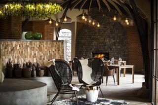 Take an Eco-Escape to a Spherical Forest Villa in an Eroded Volcanic Cone in Rwanda - Photo 6 of 10 - Recycled glass was used for chandeliers and black-and-white cow hides were used to reflect the rural way of life in the villages.