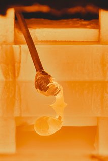 Master Glassmaker Simon Pearce's Sustainable Factory in Vermont - Photo 7 of 16 - Gathering A pipe is dipped into the furnace to collect enough molten material for the glass’s base. If the pipe isn’t constantly turned from start to finish, the glass will gain an uneven shape.