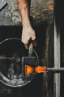 Master Glassmaker Simon Pearce's Sustainable Factory in Vermont - Photo 9 of 16 - Molding A cherry wood mold is used to shape the base of the glass. The mold is made in-house, as are all the factory's tools. 