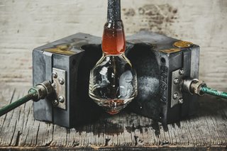Master Glassmaker Simon Pearce's Sustainable Factory in Vermont - Photo 1 of 16 - The top of the glass takes shape when the pipe is placed in a graphite mold and blown into, as the pipe is constantly spun.