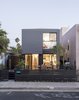 Modern home with outdoor, hardscapes, front yard, trees, large patio, porch, deck, and vertical fence. Universal design and affordability were uppermost in the minds of TJ Hill and Jay Heiserman when they asked Jared Levy and Gordon Stott of Connect Homes to replace their cramped bungalow with a modern prefab. Since the firm’s modules are 8 feet wide, the house could only be 16 feet wide, but the architects used the remaining space for a large deck, creating a flexible and seamless first-floor plan. Photo of Hill-Heiserman House