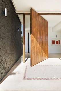 Stay in a Chic and Modern Moroccan Villa Near the Medina of Marrakech - Photo 2 of 11 - Visitors enter through an enormous wooden door that swings fully open.