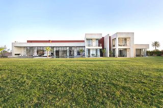 Stay in a Chic and Modern Moroccan Villa Near the Medina of Marrakech - Photo 1 of 11 - The Amizmiz House sits on a two-acre piece of land that's filled with gardens and a stunning indoor/outdoor pool. 
