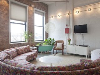 Experience New York City's Eclectic Side at One of These Modern Short-Term Rentals - Photo 3 of 11 - Decorated with a mix of bohemian and midcentury furnishings, this spacious 1,500-square-feet loft with high ceilings and exposed-brick walls is a cozy refuge in a creative neighborhood.
