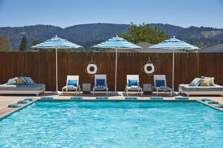 A Napa Valley Motor Lodge Reinterprets the Classic Roadside Motel - Photo 6 of 8 - Three outdoor pools are kept at three different temperatures thanks to the 180-degree Fahrenheit mineral hot springs bubbling underground. A fire pit, bocce court, games, and hammocks are perfect places for guests to hang out.