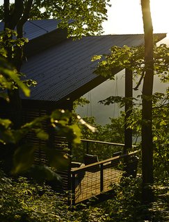 A Rustic-Modern Cabin Inspired by Japanese Bungalows and Shou Sugi Ban - Photo 7 of 12 - The cold-rolled corrugated-steel roofing from B&M Metals will gradually rust, achieving a weathered look.