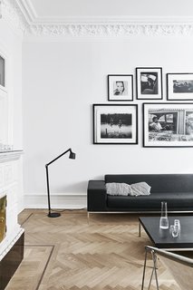 A Careful Renovation of a 19th-Century Flat in Gothenburg Brings it Back to Life - Photo 3 of 11 - The residents removed vestiges of bad renovations from the past. "The 11-foot ceiling had been lowered in some rooms, which was a popular thing to do in Sweden in the 1970s in order to save energy," Martin explains. "Some of the stucco had been destroyed, so we re-created both ceilings and windows." The restored floors are original; the residents also removed and replaced all the electrical outlets, switches, and door handles. 