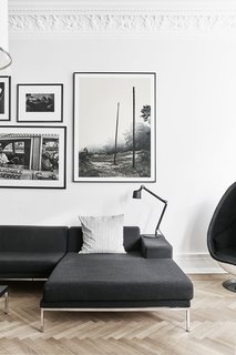 A Careful Renovation of a 19th-Century Flat in Gothenburg Brings it Back to Life - Photo 4 of 11 - In the living room, a Vipp table lamp rests on a Hockney sofa by Eero Koivisto for David Design.