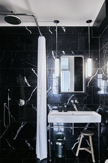 A Careful Renovation of a 19th-Century Flat in Gothenburg Brings it Back to Life - Photo 9 of 11 - The bathroom is clad in black marble sourced from Spain.