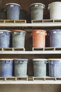 Go Behind the Scenes With a Process-Driven Handmade-Tile Company in California - Photo 4 of 13 - Gathering Raw Materials: Fireclay’s most popular clay body is made of at least <br>55 percent recycled materials, which include postconsumer glass and granite dust. The crushed and sifted powders are stored in barrels. 