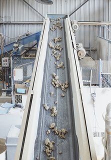 Go Behind the Scenes With a Process-Driven Handmade-Tile Company in California - Photo 6 of 13 - Extrusion, Part I: Mixed clay moves on a conveyer belt to "the Junior," a 25,000-pound extruder built by the Plymouth Locomotive Company in the 1940s. It pumps out enough compressed clay each day for an estimated 2,500 square feet of tiles. 