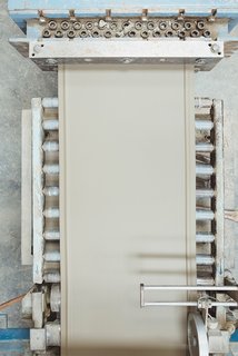 Go Behind the Scenes With a Process-Driven Handmade-Tile Company in California - Photo 7 of 13 - Extrusion, Part II: Wet clay is packed into the extruder and ribbons of compressed clay emerge continuously before going to the "cookie-cutter," which is connected to the Junior.