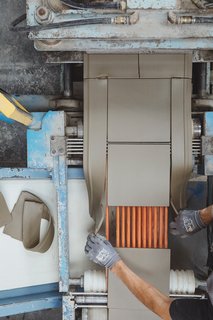 Go Behind the Scenes With a Process-Driven Handmade-Tile Company in California - Photo 8 of 13 - Cutting Extruded: Clay is trimmed into nine-by-nine-inch squares. The excess is sent back to the extruder by a conveyer belt, so no material is wasted.