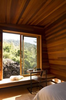 Two Tiny Pavilions Respectfully Perch Atop a Lava Flow on Maui - Photo 3 of 8 - Detailed in cedar paneling and plywood, Mauka was oriented to catch the sunrise. The table is by Moore’s firm, FLOAT.