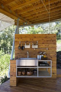 Two Tiny Pavilions Respectfully Perch Atop a Lava Flow on Maui - Photo 7 of 8 - The kitchen contains a Kohler sink and pot racks from IKEA.