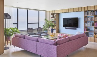 An Interior Designer Helps His Mother Turn Her 1960s Chicago Apartment Into a Colorful Haven - Photo 4 of 8 - From the 33rd floor, the view of Lake Michigan is expansive. Linen curtains from The Shade Store filter sunlight. Extra lighting is provided by LED ceiling lights, a Tatou F floor lamp by Patricia Urquiola, and a Copycat table lamp by Michael Anastassiades for Flos.