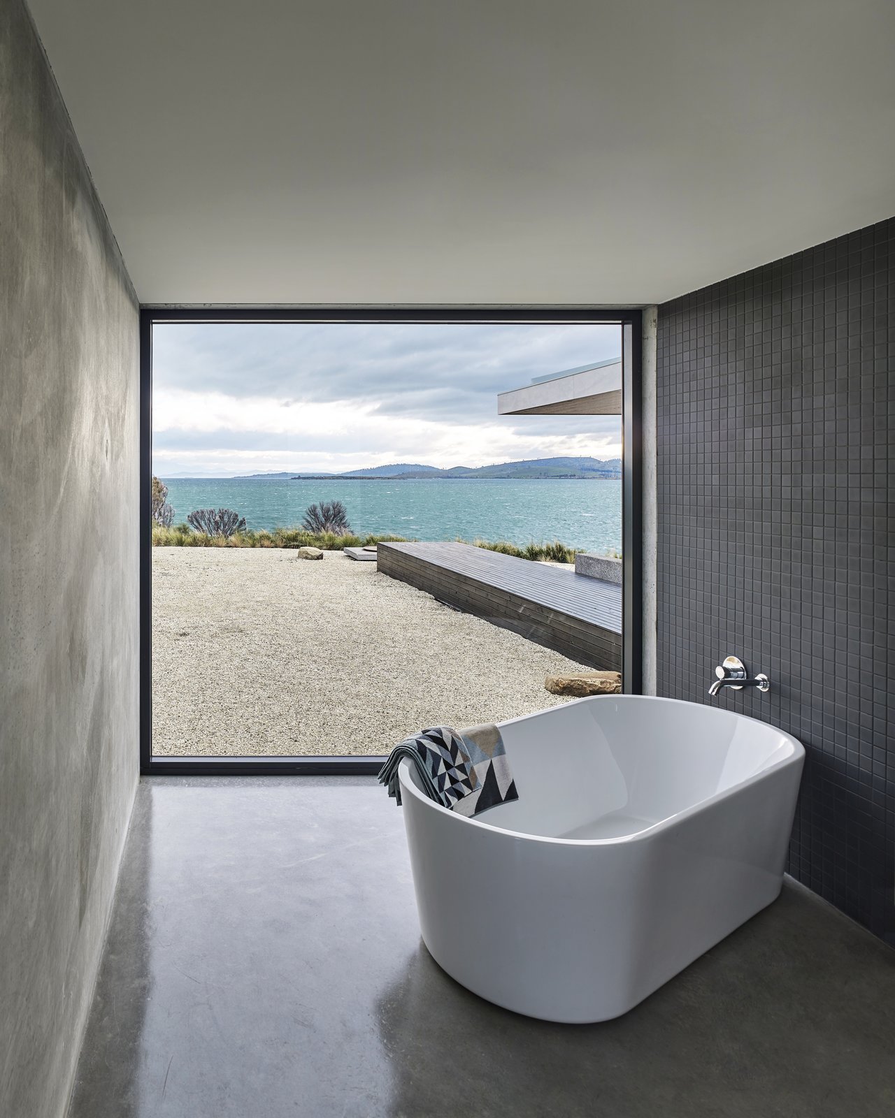 The corner bathroom is defined by a freestanding Kado Lure 1760 tub and a powerful view of the bay.
Tasmania, Australia
Dwell Magazine : September / October 2017