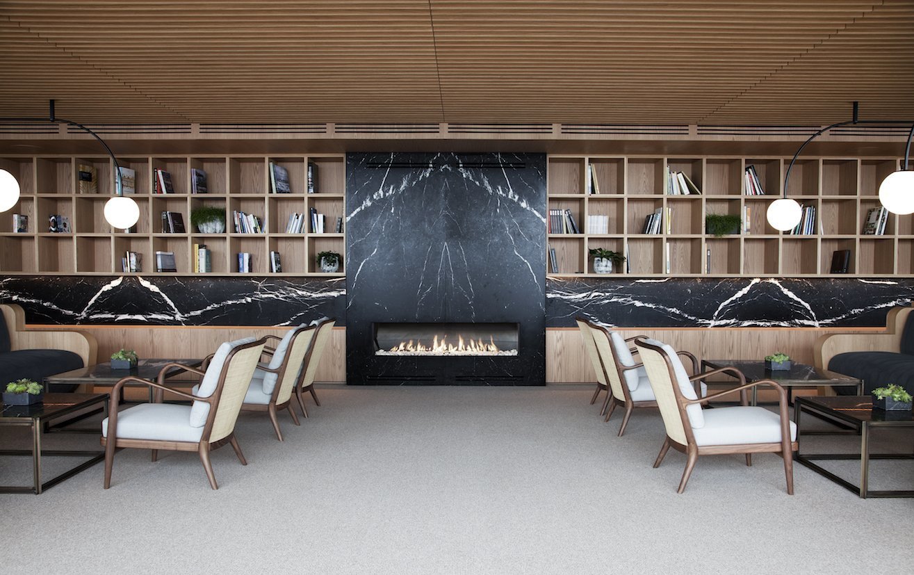 The hotel's interiors emphasizes the use of natural materials such as stone, wood, and linen.
The hotel's interiors are equally notable for their elegant and contemporary decor that emphasizes the use of natural materials. The common areas are paneled in wood—a theme that runs throughout the public spaces—seamlessly interconnecting them. The minimalist guest rooms also feature warm wood paneling and floor-to-ceiling windows and terraces. Interiors are furnished with pieces from Spanish furniture maker Kettal, including the collaborative collections Bitta and Boma by Rodolfo Dordoni, Park Life by Jasper Morrison, and Cala by Doshi Levien.