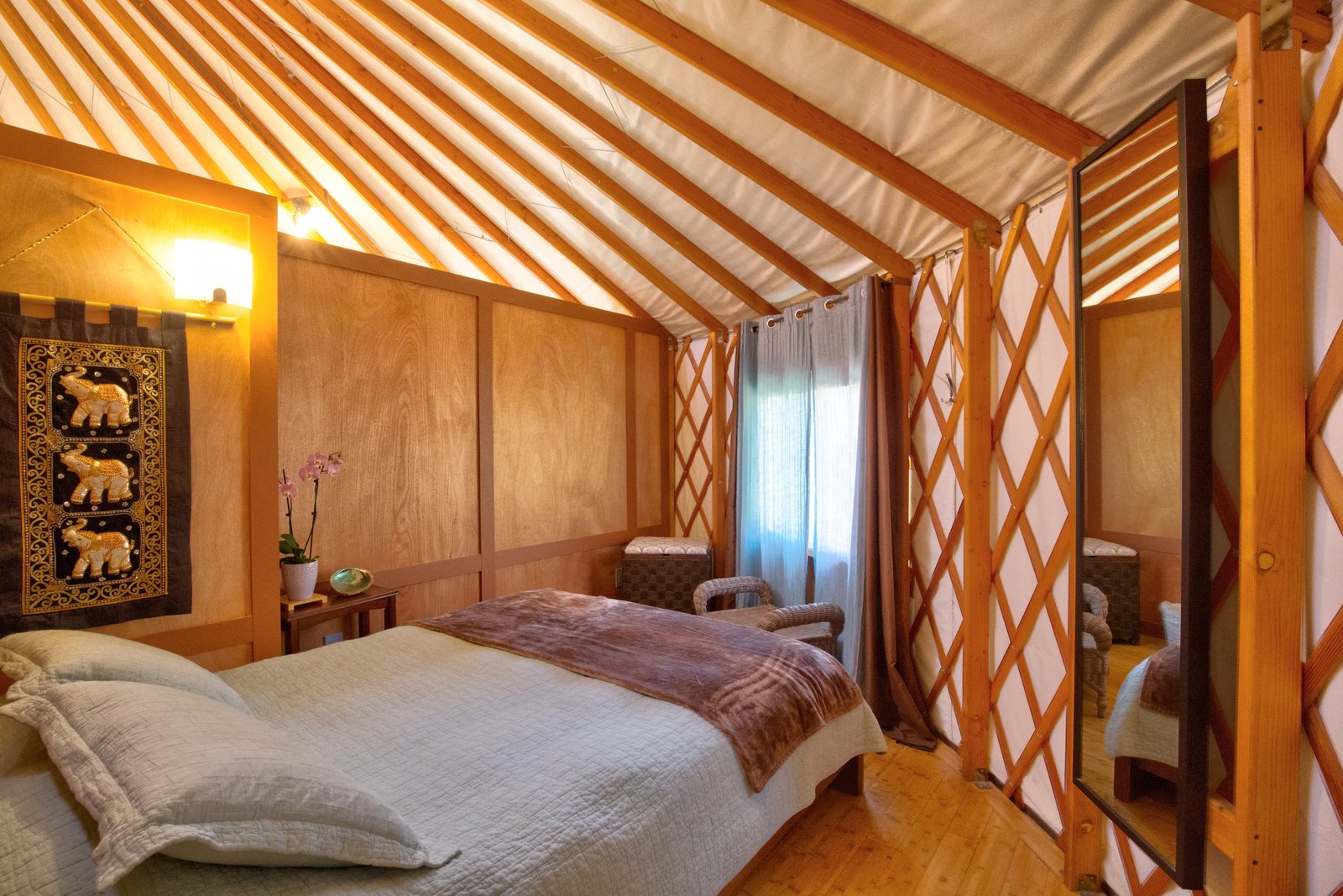 The smaller bedroom is tucked behind a partition for privacy.