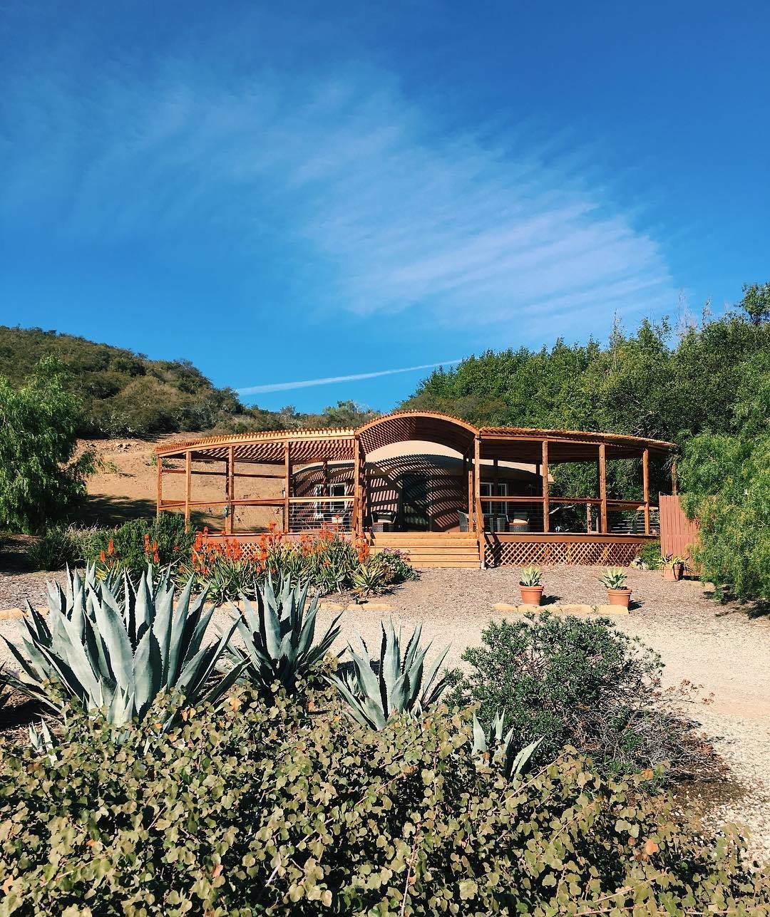 Adrian Larralde built the original yurt in 2010 and added the porch in mid-2017, extending the living space toward beach views.