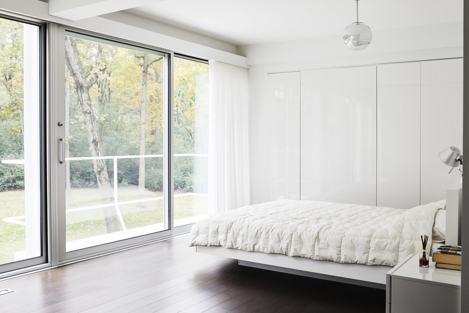 All of the existing windows were replaced with newer versions by the company that did the originals, Arcadia. The master bedroom and bathroom are located where the kitchen and dining area once were. The floating bed is by TemaHome and the Mirror Ball pendant is by Tom Dixon.