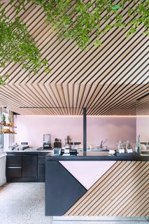 How to Design with Pink - Photo 15 of 15 - Designed by Standard Studio, the graphic store uses a palette of black and pink powder-coated metal and diagonally aligned wood slats. Photo by Wouter van der Sar.