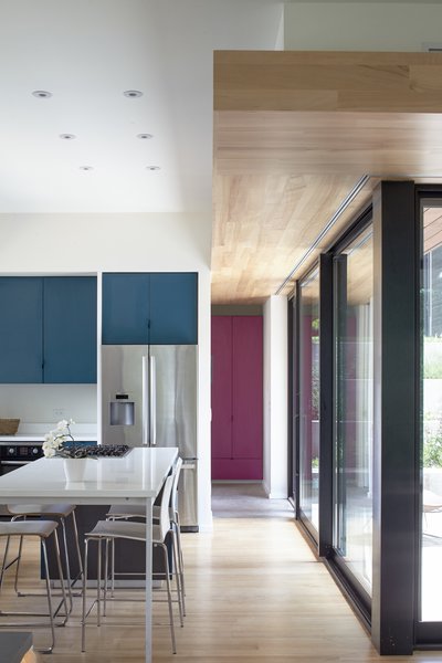 The interiors are outfitted with beech floors and soffits. Custom laminate cabinets in varying colors create storage throughout the home.