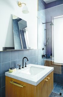 You Won't Lose Your Wi-Fi Connection at This Hamptons Retreat - Photo 6 of 6 - The bathrooms are outfitted with Jason Wu for Brizo fixtures. The Bestlite BL7 wall lamp by Robert DudleyBest for GUBI hangs above a marble-topped vanity.