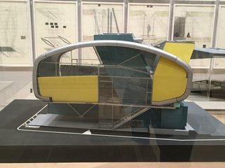 In an adjacent room, various forms of experimental architecture are explored with renderings, sculptures, models, and sketches. Shown here is Neil M. Denari's model for Prototype House, Tokyo, created from 1992 to 1993. Though this design was never actually built, it represented his idea of creating "living machines" as a solution to confined urban living.