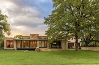 Forging a Connection to the Texas Skies One Window at a Time - Photo 1 of 3 - Throughout the Sunnybrook residence, stacked stone and cut Leuders limestone anchors the structure to its natural setting. To create the transparent facade, SHM Architects chose to include a selection of options from Marvin Windows and Doors including Ultimate Casements and Ultimate Casement Picture Windows. Lohr designed a custom frosted front door to block any direct lines of sight from the street. Courtesy of Marvin Windows and Doors.