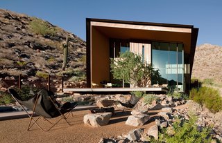 Taking it to the Desert With Dwell Home Tours - Photo 1 of 12 - One of our featured homes is the Jarson Residence, designed by Will Bruder of Will Bruder Architects and characterized by a simple shed roof with deep overhangs. The exterior of the sculptural structure is covered with rusted steel and copper that blends well with the surrounding rocky topogrpahy. 