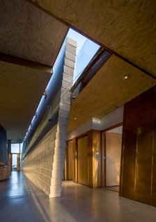Taking it to the Desert With Dwell Home Tours - Photo 9 of 12 - The Bryne Residence is made up of tilted masonry "canyon walls" and a combination of naturally patinated copper and acid etched galvanized metal. Because of the implementation of these materials, the color of the house changes with the shifting sunlight.