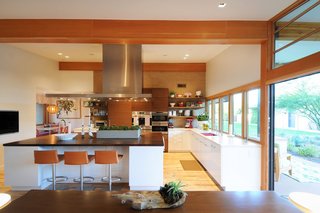 Taking it to the Desert With Dwell Home Tours - Photo 11 of 12 - Throughout the house, Woolsey opened up confined rooms to create spacious areas where the family can live and play together. One example is shown here, where she expanded the kitchen by connecting it to a banquet breakfast area.