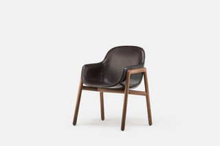 Bringing Back a Forgotten Material - Photo 2 of 7 - Along with the black-on-black option shown here, the Stella Armchair is also available in white, with the option to have either color in a glossy or matte finish. For additional freedom, the inner upholstery can be done in various different kinds of fabric or leather, while the base can be fitted with American black walnut (as shown here) or a lighter European ash. 