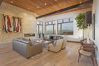 Proof That a Modern Fireplace Can Be the Defining Factor of a Space - Photo 5 of 7 - This modern mountain escape is outfitted with cutting-edge technology and sits seamlessly within the landscape of Woodland Hills, Utah. Its immense vistas are accentuated by a sleek fireplace that’s surrounded by a more organic placement of stone. 