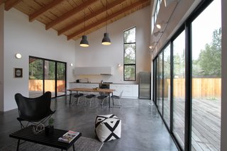 Loewinger opted out of building a big island that would take up the entire kitchen. Instead, she kept the cooking surface confined to the far wall and used the rest of the space to create an open dining area. The oversized hanging pendant lights are from Ikea. 