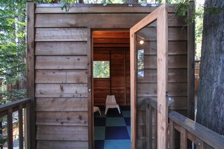 When Loewinger consulted with her daughter about how she imagined the interior of the tree house, she chose a two-tone blue tile treatment from Flor. The child-size outdoor chairs are from Ikea. 