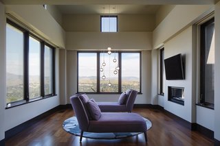 This House Takes on Gusty Winds and an Earthquake Fault - Photo 6 of 9 - The sitting area off the master bedroom reveals views of Mount Diablo and the surrounding landscape. The inside of the Marvin casement windows are made up of Douglas fir that’s been finished in a dark wood stain. For the exterior, he opted for aluminum-clad casements with a bronze finish. 