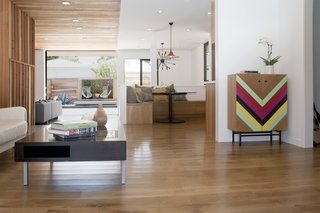 DEX Studio designed this home for a family with Midwestern roots who wanted to be able to enjoy indoor/outdoor living as much as possible. The wood from the exterior continues indoors where it helps divide the public and private spaces. Large surface mounted sliding doors open up to the backyard and pool. 