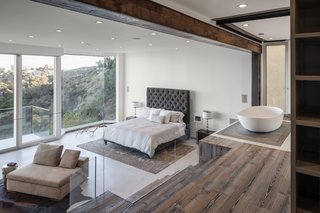 This view shows off the master bedroom suite and a peek into the master bath. The house is filled with reclaimed wood and steel, as well as an impressive selection of automated features. 