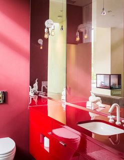 The vibrant color scheme is continued throughout the property, even into the smallest of spaces—as shown here in one of the bathrooms. 