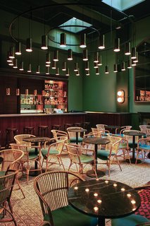 A Boutique Hotel That Captures the Creative Spirit of Barcelona - Photo 1 of 12 - Hovering over the Libertine bar/restaurant in Casa Bonay is a massive lighting installation by Santa & Cole. As a Barcelona-based company that focuses on industrial design, they also provided the lighting throughout the rest of the hotel.