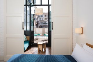 A Boutique Hotel That Captures the Creative Spirit of Barcelona - Photo 8 of 12 - The floors of the guest rooms are still covered with the original mosaic tiles. The blankets in the rooms were handcrafted by Teixidors, a nonprofit company based outside of Barcelona that provides opportunities for individuals with learning disabilities.