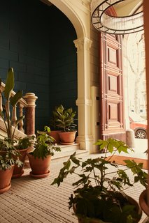 A Boutique Hotel That Captures the Creative Spirit of Barcelona - Photo 12 of 12 - In the main corridor of the refreshed 19th century building, lush potted plants from Alejandra Coll of Asilvestrada Plants sit on top of original mosaic floors. 