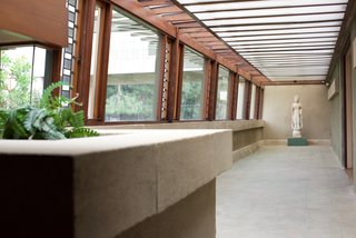 Iconic Perspectives: Frank Lloyd Wright's Hollyhock House - Photo 8 of 13 - Since Wright was simultaneously working on the Japanese Imperial Hotel, he incorporated many Japanese details in the design of the Hollyhock House. Along with the Japanese screens in the living room, there's also a Buddhist sculpture at the end of a long hallway that’s lined with art glass.