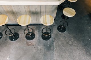 The Classic Hand Roll Bar Makes a Comeback at a New Los Angeles Sushi Spot - Photo 4 of 4 - Customers are given the freedom to seat themselves with a "self-regulating line" concept. The stained concrete floors feature a subtle stencil pattern and a rough, weathered texture that's reflected throughout the rest of the space.