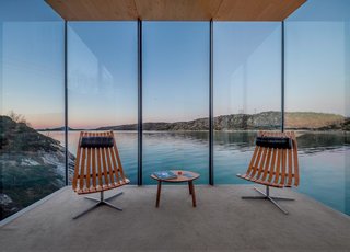 10 Gravity-Defying Cantilevered Homes - Photo 13 of 23 - The large expanses of glass frame views that were perfectly planned. The seating areas are furnished with Scandia lounge chairs that were designed by Hans Brattrud in the 1950s and are now being produced by Fjordfiesta.